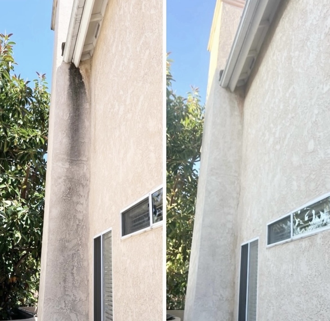 Two-story stucco wall with mildew streaks, then clean